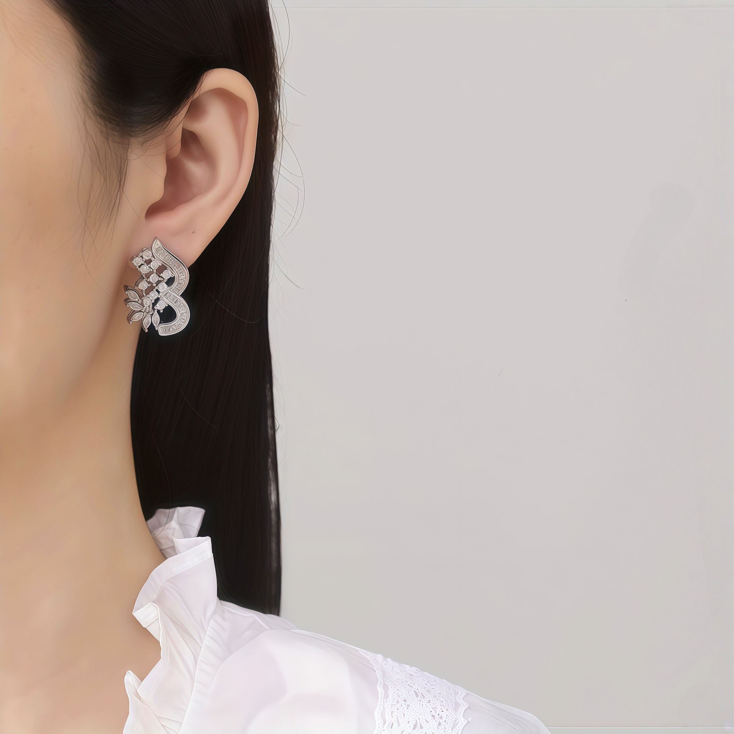 Curved floral CZ stud earrings with marquise crystal details - image 2
